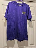 Full front view of purple Disney T-shirt on hanger