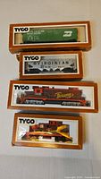 Stacked view of all four boxed Tyco items