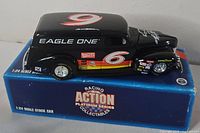 Die-cast car on its box, showing livery and scale