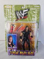 Front of sealed WWF Sunday Night Heat Undertaker figure showing accessories and packaging details