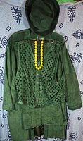 Emerald green hooded suede coat, perforated vest, skirt and hat displayed together