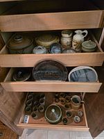 Overview of drawers showing majority of stoneware pieces