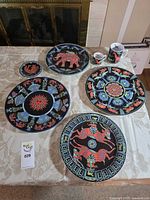 Full set on table showing all five plates and two mugs
