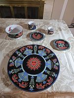 Front view showing all six BOPLA! porcelain pieces on table