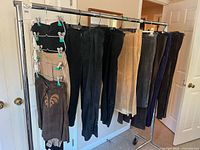 Rack showing twelve leather and suede skirts and pants sizes 12-14