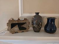 All three studio pottery vases on mantle