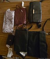 Group shot of six handbags and wallets on table