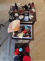 Top view showing perfume bottles with boxes and fan plus tray of hair clips