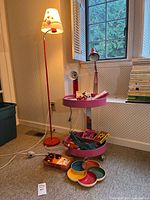 Scene showing floor lamp, rolling cart, serving tray, desk lamp, fan and stationery