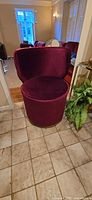 Front view of burgundy velvet barrel chair