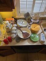 Countertop view showing majority of cookware, ceramics, spice jars and utensils