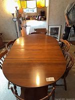 Dining table with chairs around it, leaves inserted