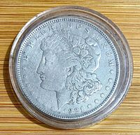 Obverse of 1921 Morgan dollar in capsule