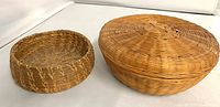Small coiled pine basket and lidded sweetgrass basket overview