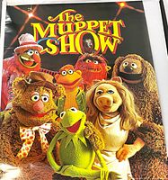 Front view showing full Muppet Show cast image and logo