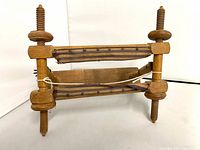 Front view showing full wooden embroidery frame with threaded screws and stretcher bars