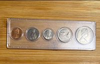 Obverse view of five coins in plastic holder