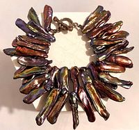 Bracelet arranged in circle showing stick pearls and clasp