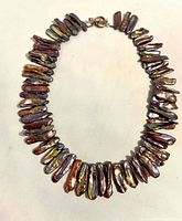 Full necklace laid flat showing stick pearls and clasp