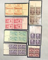 front view of all seven plate blocks showing designs, colors and plate numbers