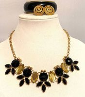 Necklace displayed on form with bangle and earrings