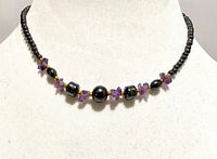 Necklace on display form showing bead arrangement and clasp type