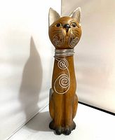 Full view of carved wooden cat statue front
