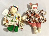 Both cloth cat dolls side by side