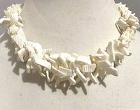 Close-up of shell and coral fragments on necklace