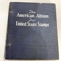 Front cover of blue cloth stamp album with silver title text