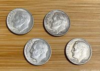 Obverse of four Roosevelt dimes showing dates 1964-D, 1963, 1953-D, 1957