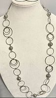 Full view of silver-tone hoop necklace on bust