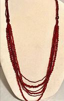 Necklace displayed on bust showing multi-strand drape and bead pattern