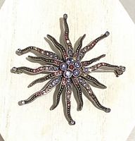 Front view of starburst brooch showing rhinestone pattern