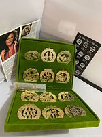 Open case displaying ornaments, hooks packet, brochures visible