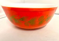 Side view showing orange exterior and gold pine motif