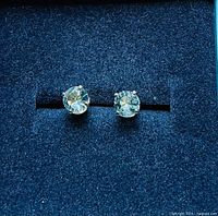 Front view of both aquamarine studs in case