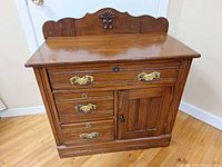 Front view of washstand showing drawers, door and hardware