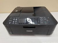 Front angled view of Canon Pixma printer showing control panel and paper tray