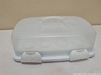 Cupcake carrier showing front with lid and latches