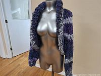 Full front view of hand knit shrug on mannequin