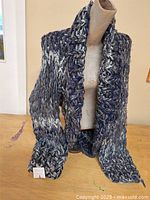 Full view of hand knit shrug displayed on mannequin torso