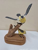 Overall view of carved goldfinches on driftwood base