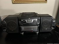 Front view showing main unit and both detachable speakers