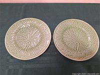 Both matching majolica plates side by side
