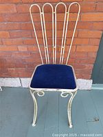 Full view of metal chair showing frame, seat and legs