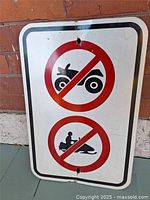 Full view of rectangular prohibition sign showing both ATV and snowmobile symbols