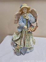 Full view of 13" musical angel figurine showing overall design and height reference