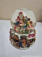 Full view of Kirkland musical waterglobe showing glass dome and detailed rotating base