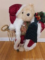 Full view of 25" teddy bear in Santa outfit standing on wood floor